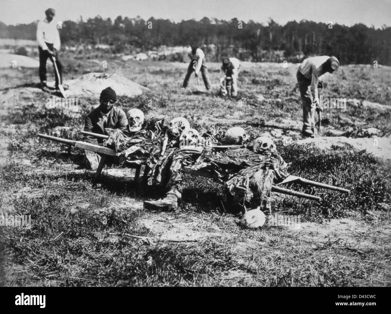 Black slaves burying dead soldiers following the battle of Cold Harbor, Virginia June 14, 1864. The battle is one of the bloodiest, most lopsided battles where thousands of Union soldiers were killed or wounded in a hopeless frontal assault against the fortified positions of Confederate Gen. Robert E. Lee's army. Stock Photo