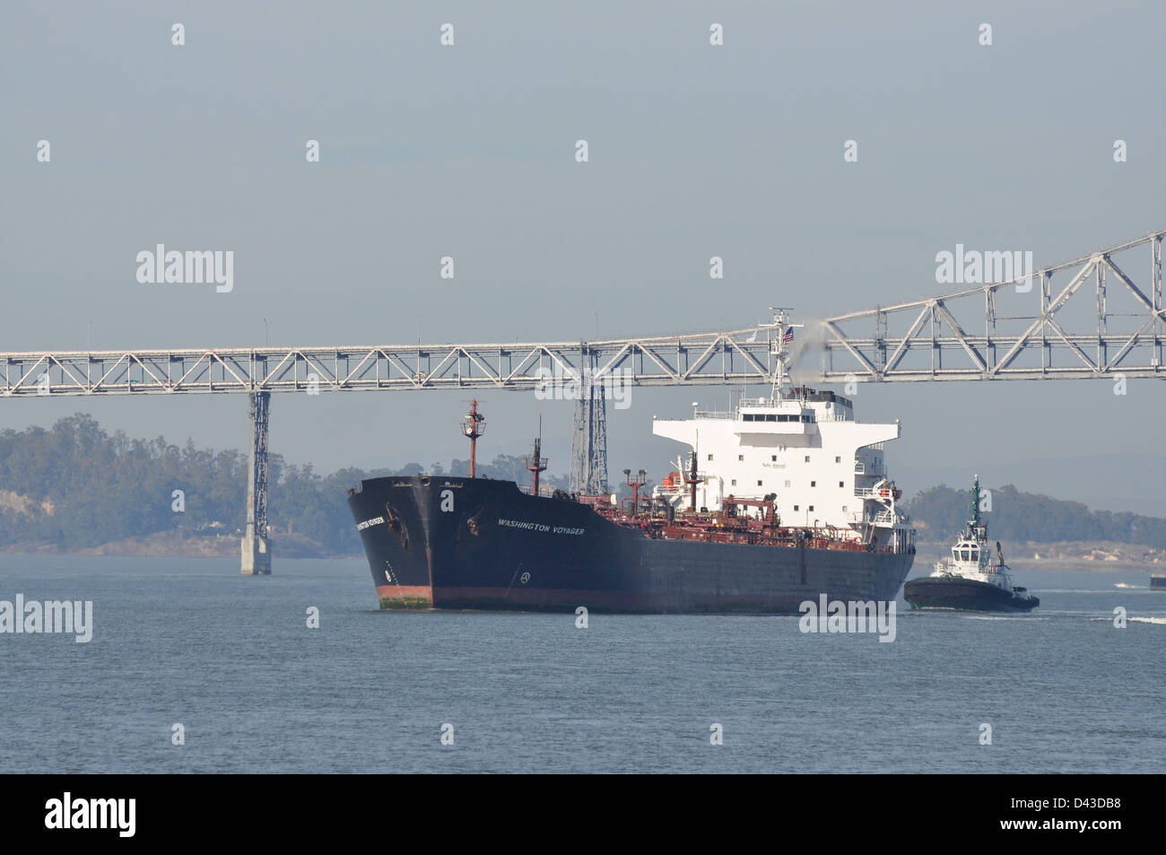 A large oil tanker leaves San Francisco under the Richmond-San Rafael Bridge. Stock Photo