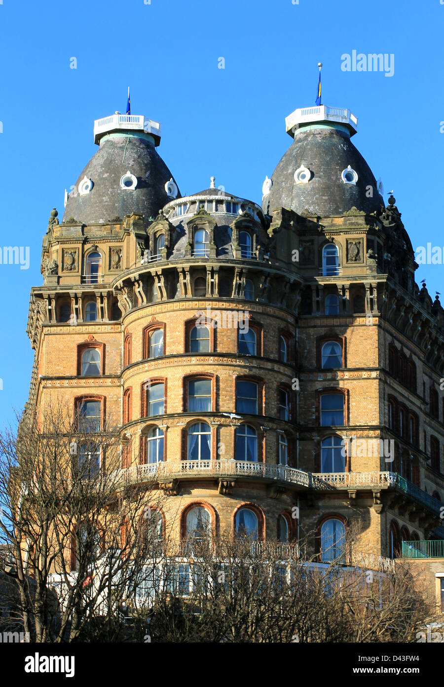 Exterior of old gothic style hotel building with blue sky background. Stock Photo