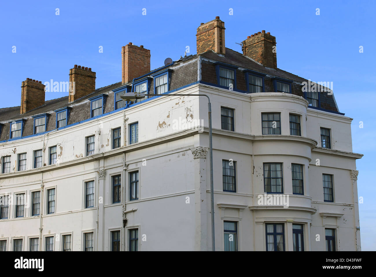 Exterior of old hotel building with blue sky background. Stock Photo