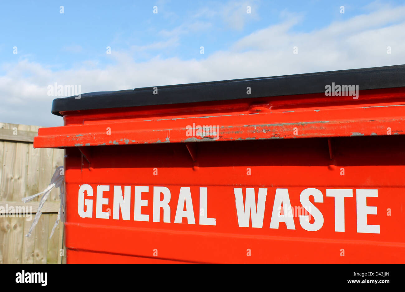 Industrial general waste bin with cloudscape background. Stock Photo