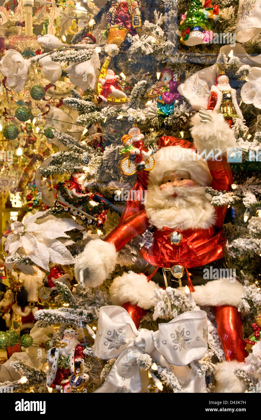 Santa Claus in illuminated designer luxury boutique Christmas window display Via Montenapoleone Milan Lombardy Italy Europe Stock Photo
