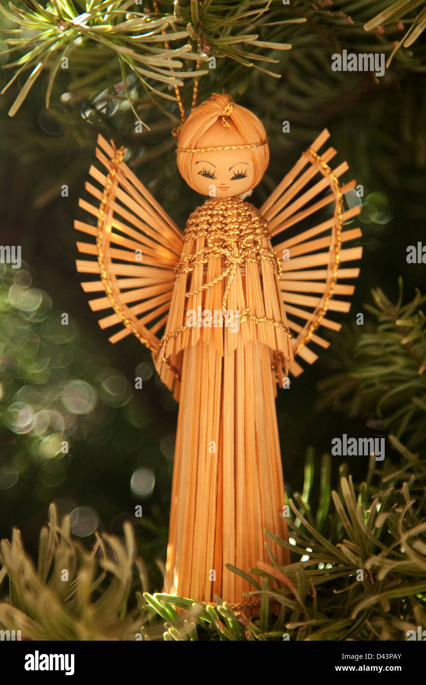 Angel ornament hanging from Christmas tree Stock Photo