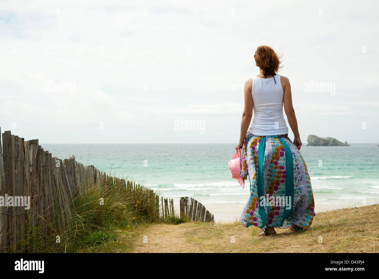 Rear View of Woman Walking on Beach, Camaret-sur-Mer, Crozon Peninsula, Finistere, Brittany, France Stock Photo