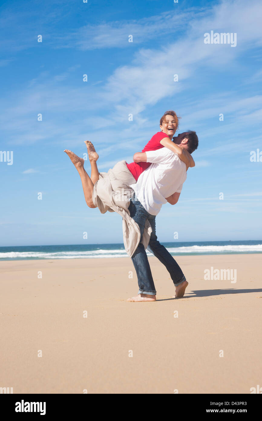 Playful Mature Couple on the Beach, Camaret-sur-Mer, Crozon Peninsula, Finistere, Brittany, France Stock Photo