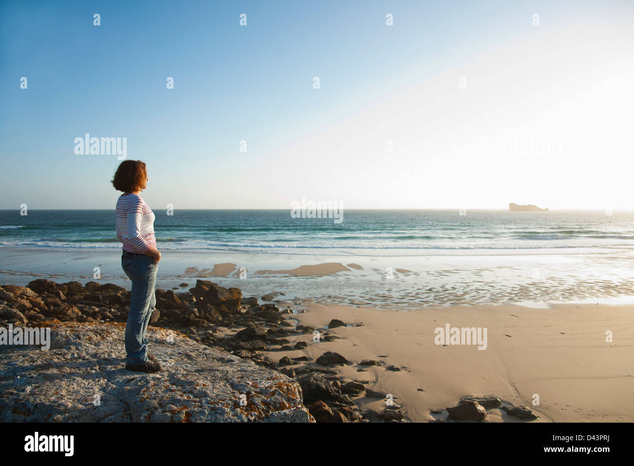 Woman Looking into the Distance at the Beach, Camaret-sur-Mer, Crozon Peninsula, Finistere, Brittany, France Stock Photo