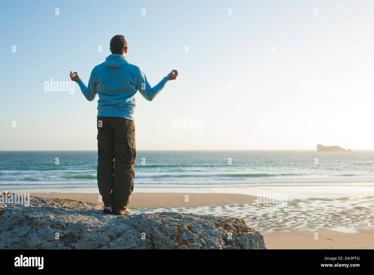 Man Meditating at the Beach, Camaret-sur-Mer, Crozon Peninsula, Finistere, Brittany, France Stock Photo