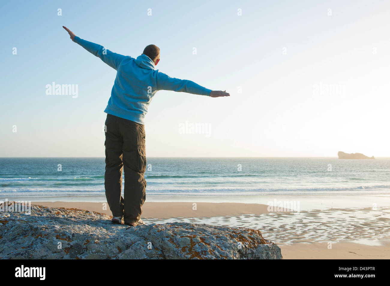 Man with Open Arms at the Beach, Camaret-sur-Mer, Crozon Peninsula, Finistere, Brittany, France Stock Photo