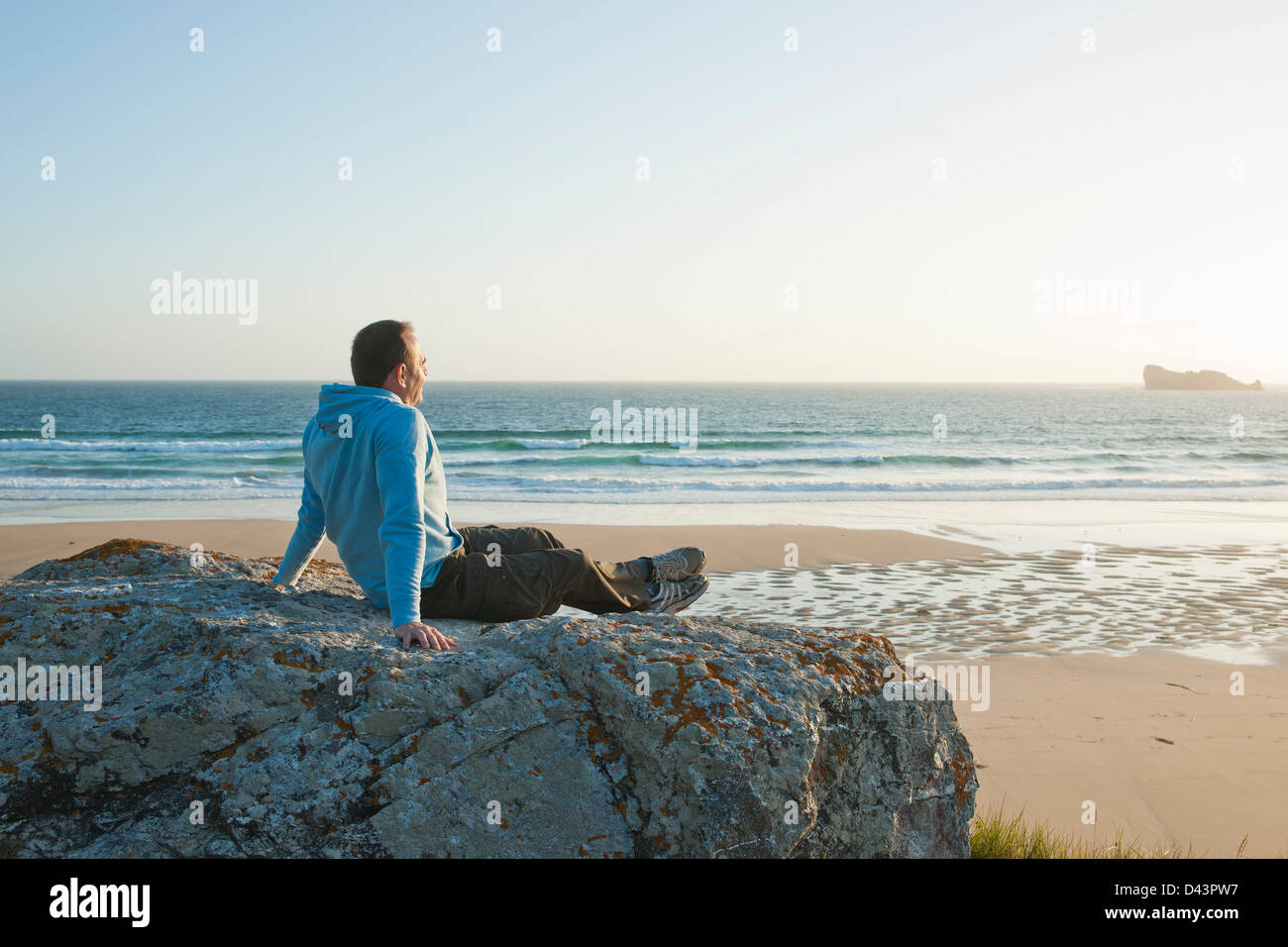 Man Looking into the Distance at the Beach, Camaret-sur-Mer, Crozon Peninsula, Finistere, Brittany, France Stock Photo