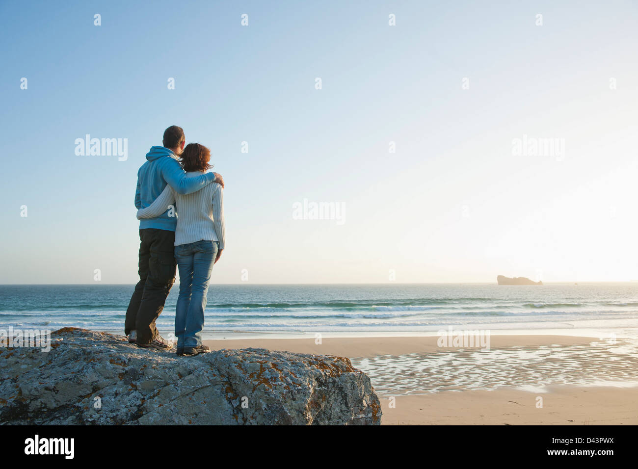 Mature Couple Looking into the Distance on the Beach, Camaret-sur-Mer, Crozon Peninsula, Finistere, Brittany, France Stock Photo