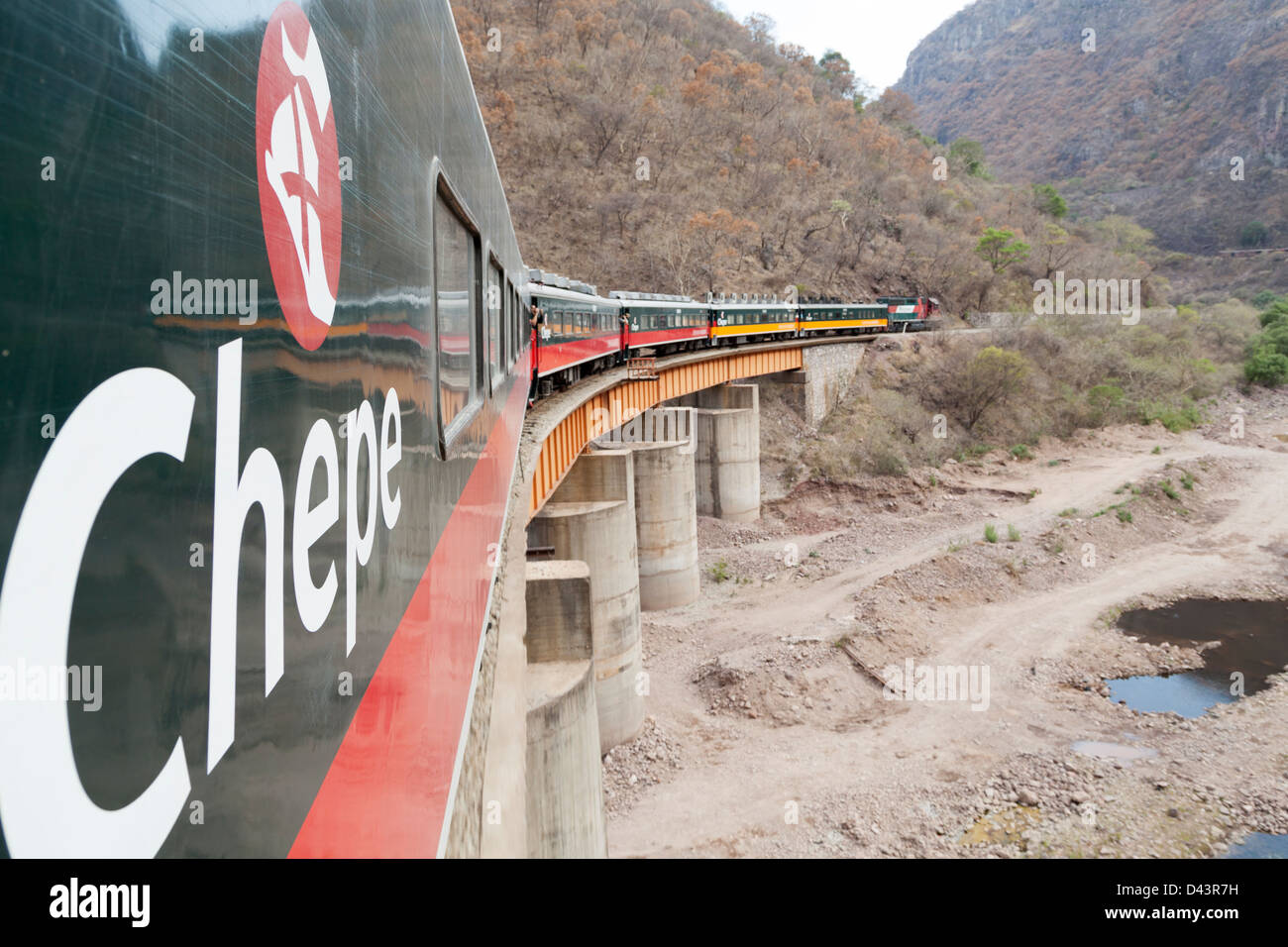 Tourist taking pictures along from the train in the Copper canyon in