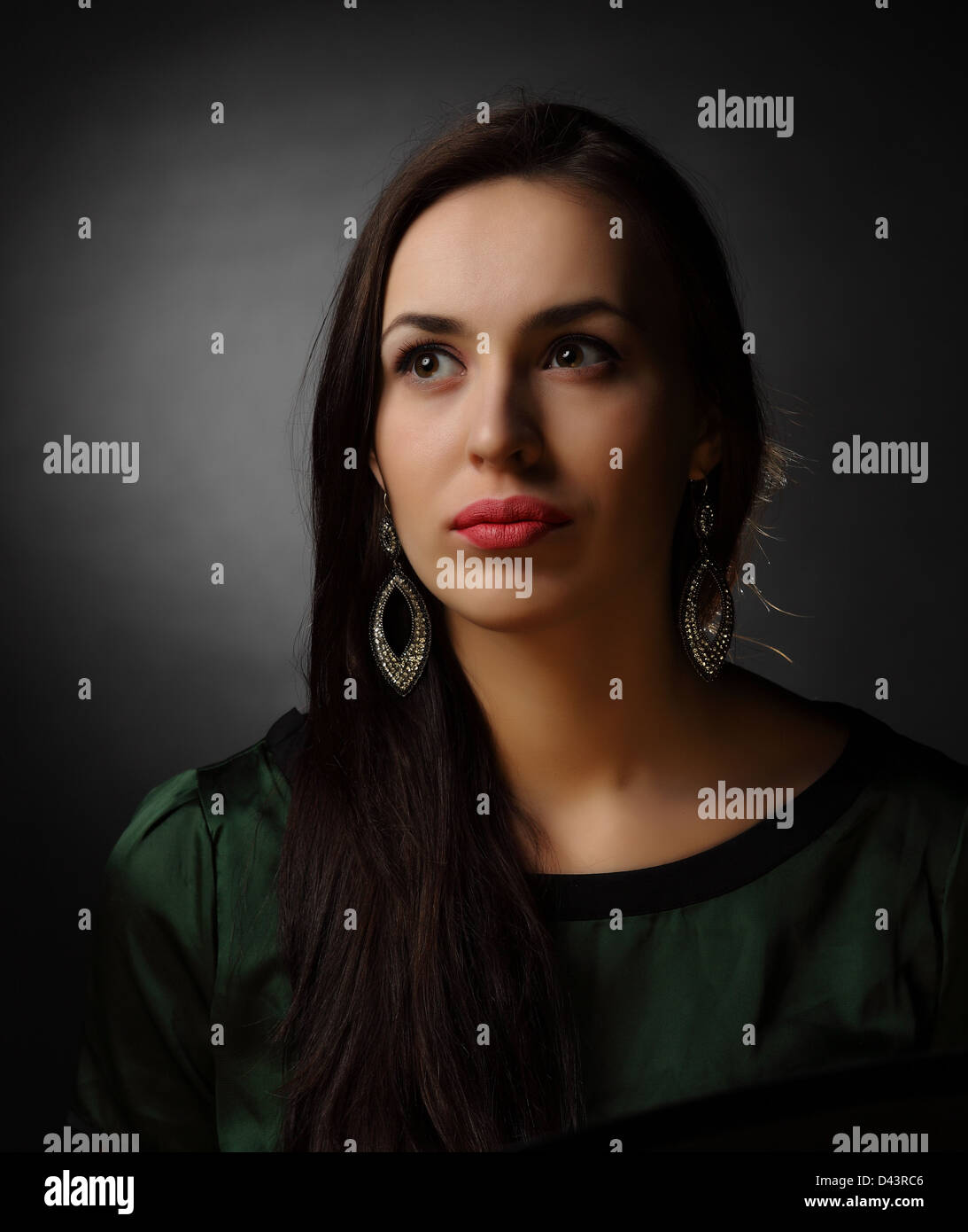 studio shot: portrait of a young beautiful woman on black background ...