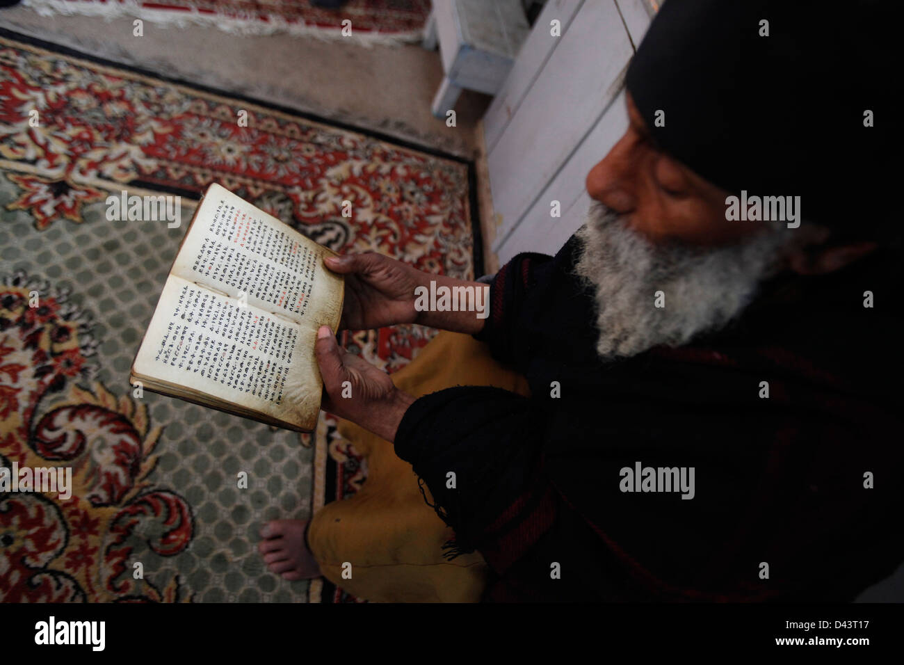 An Ethiopian orthodox monk reading the bible in Amharic Stock Photo