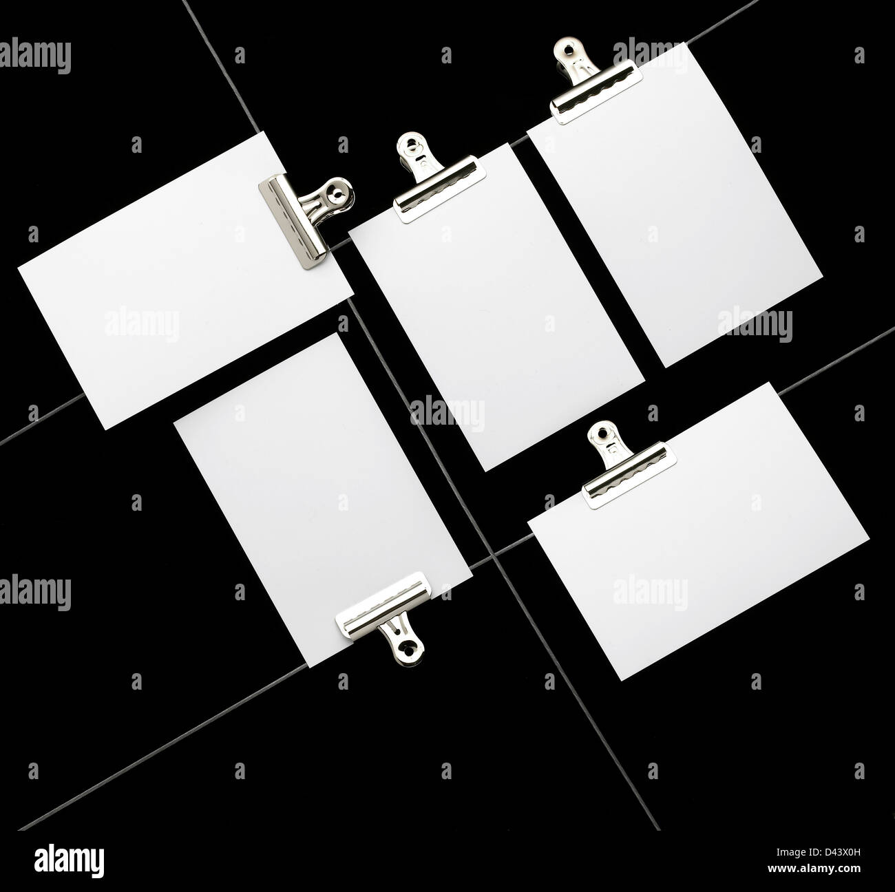 Paper clipped to crossed wires cut out black background Stock Photo - Alamy