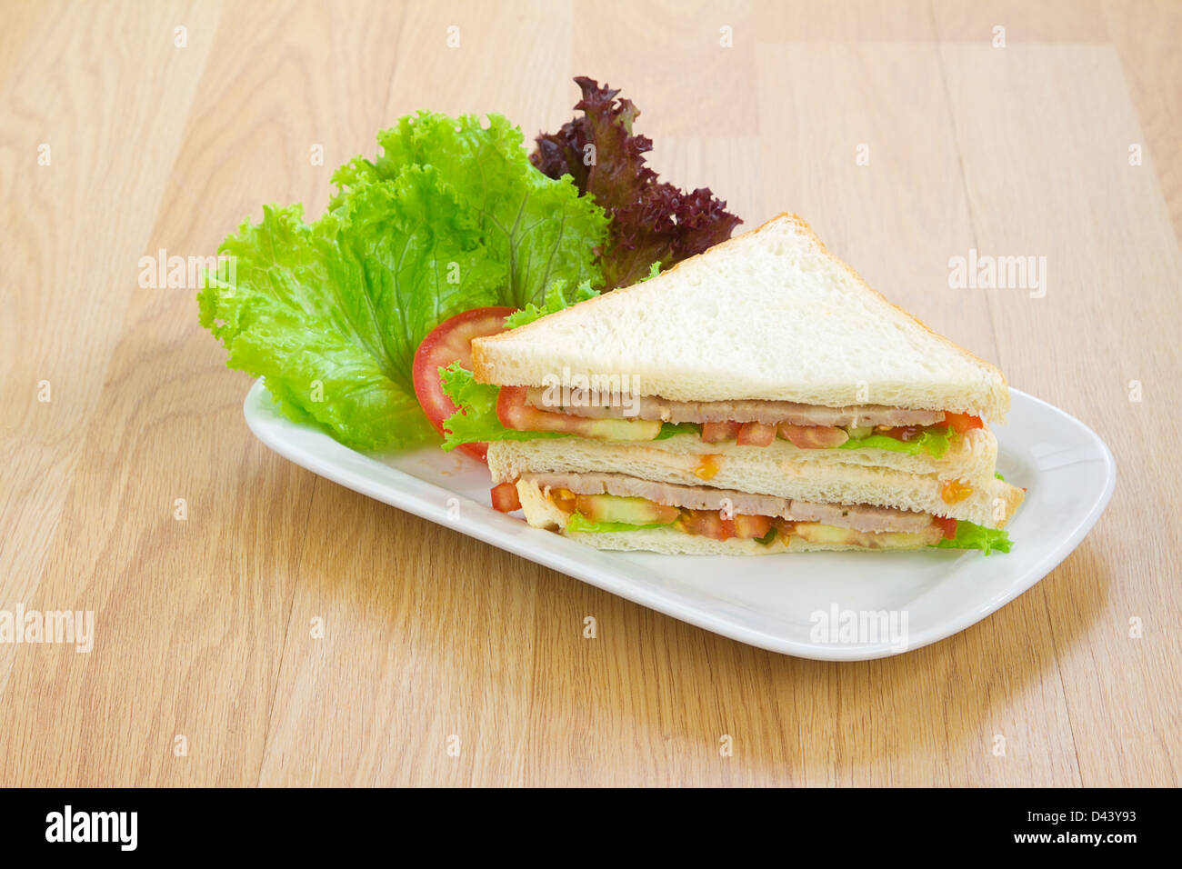 Clean and eatable ham sandwich with vegetables on the wooden kitchen Stock Photo