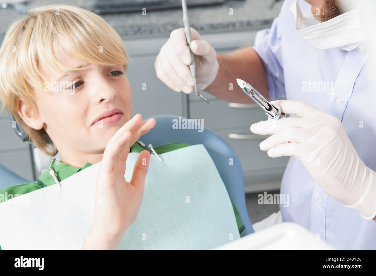 Boy declining Needle at Dentist's Office during Appointment, Germany