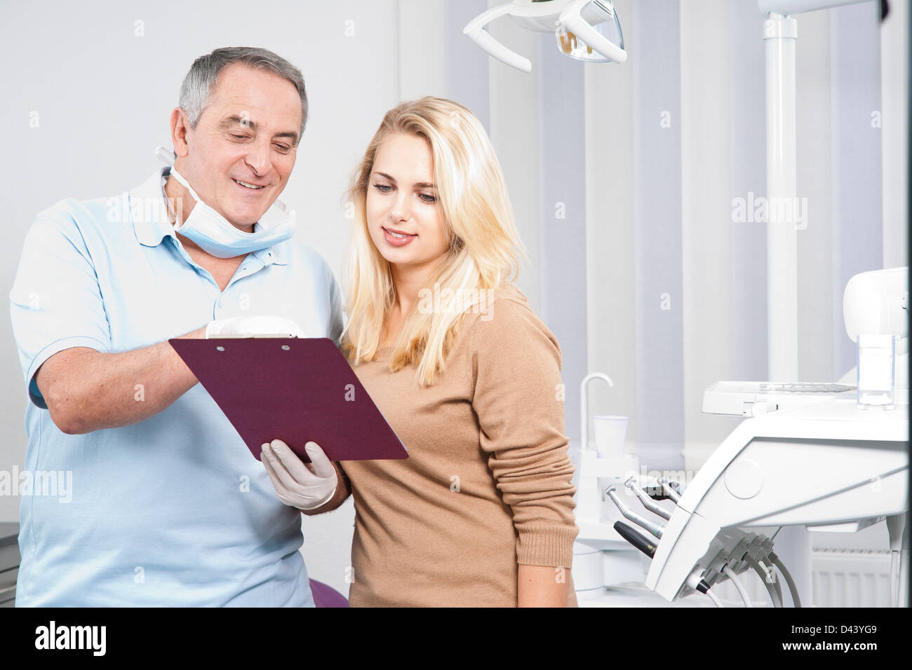 Dentist Explaining Medical Chart to Patient in Dentist's Office