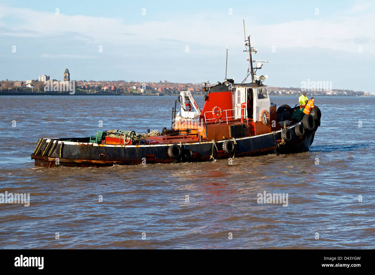 Small motor vessel travelling in river Mersey Stock Photo