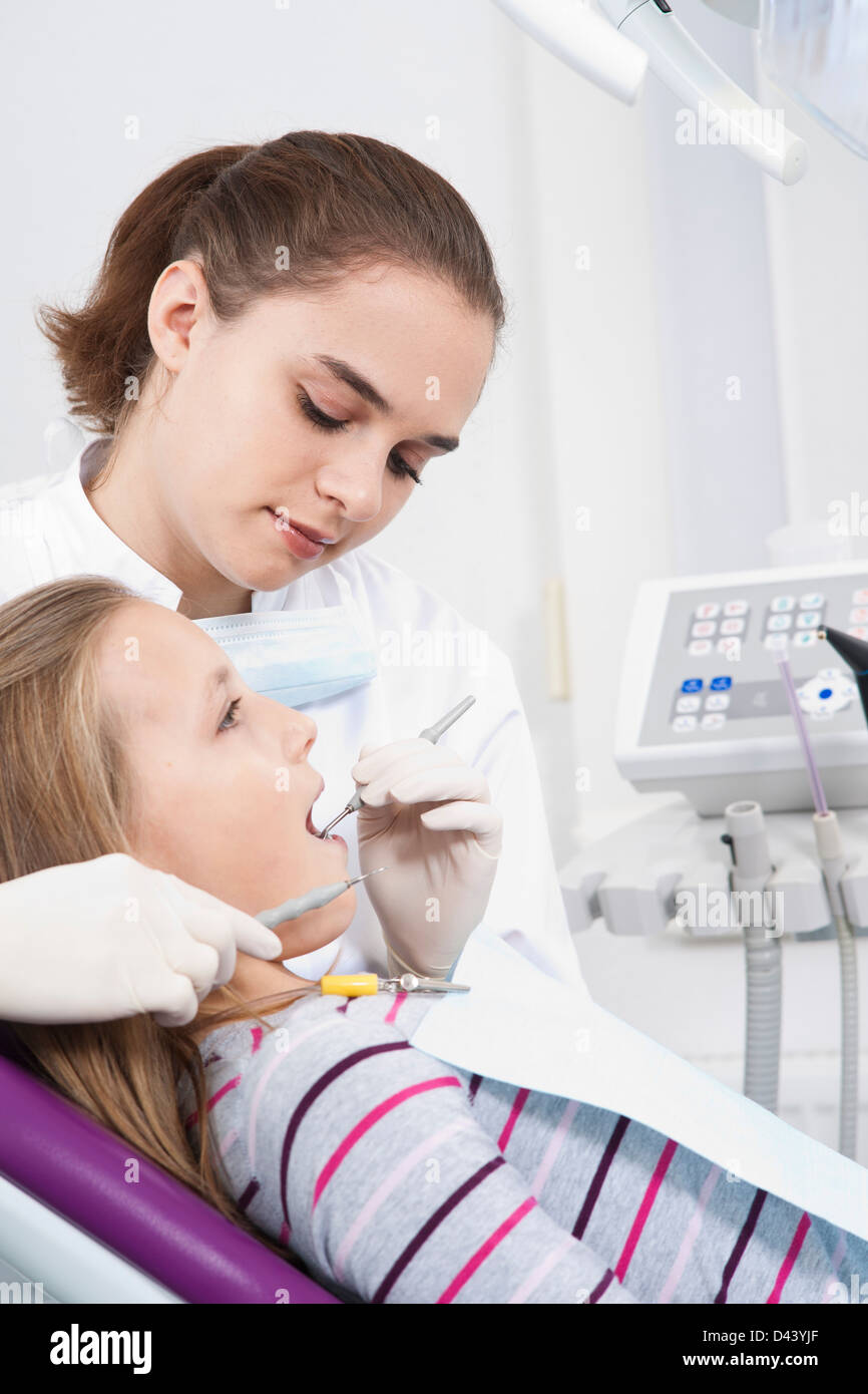 Dentist Checking Girl's Teeth during Appointment, Germany Stock Photo