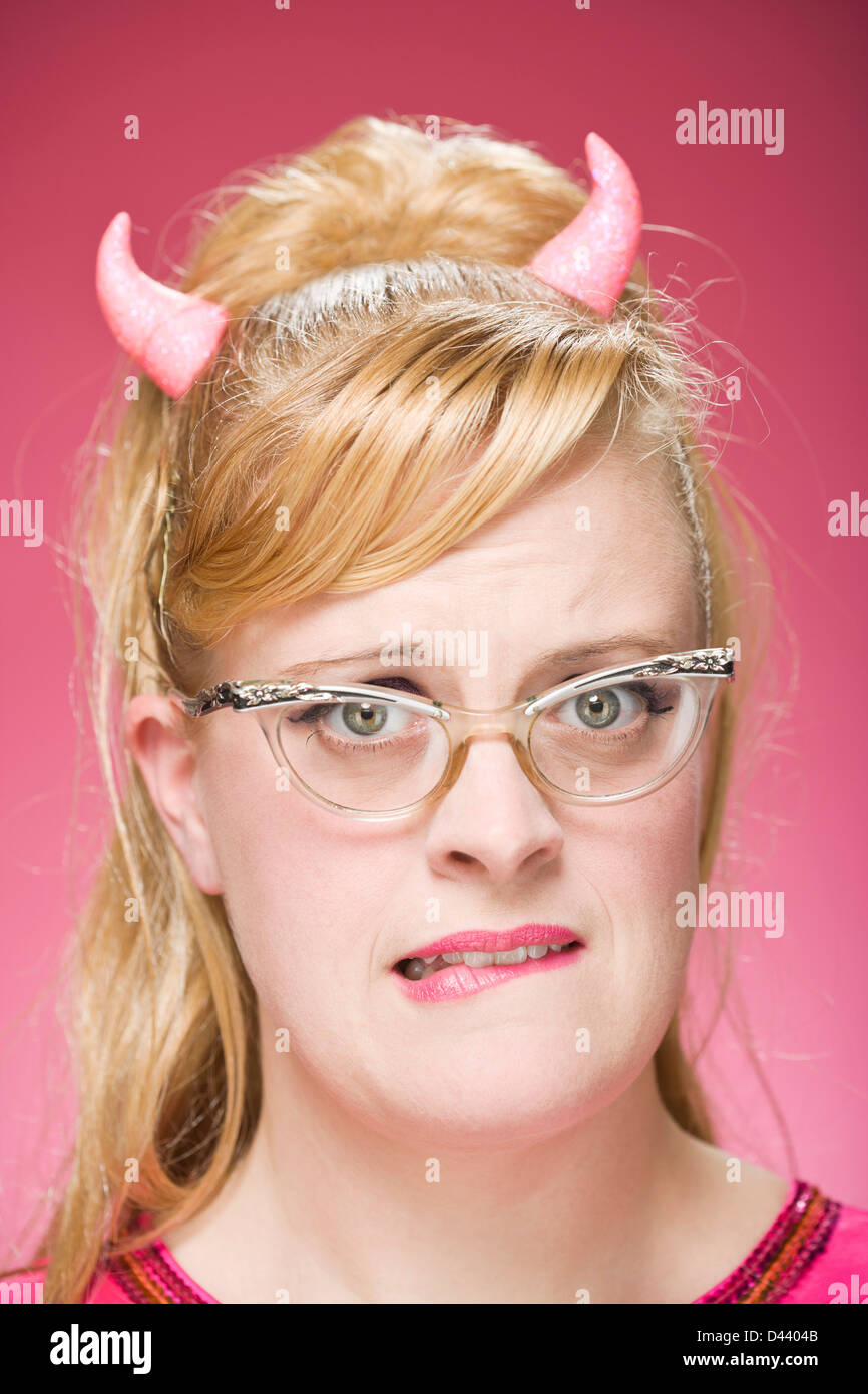 Portrait of Woman Wearing Devil Horns and Vintage Eyeglasses Stock