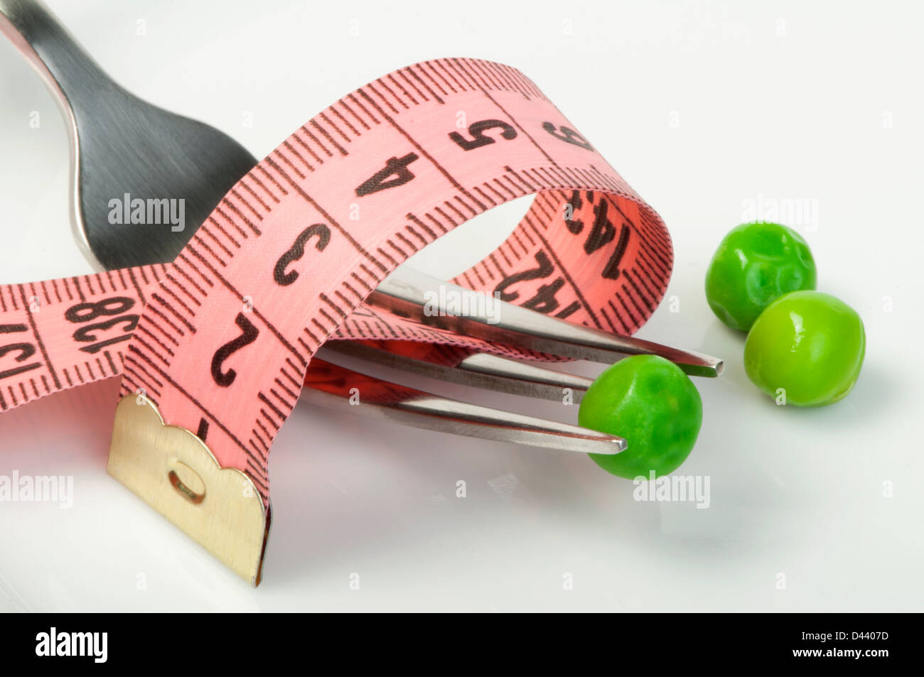 Plate with peas and centimeter measure close up. Stock Photo