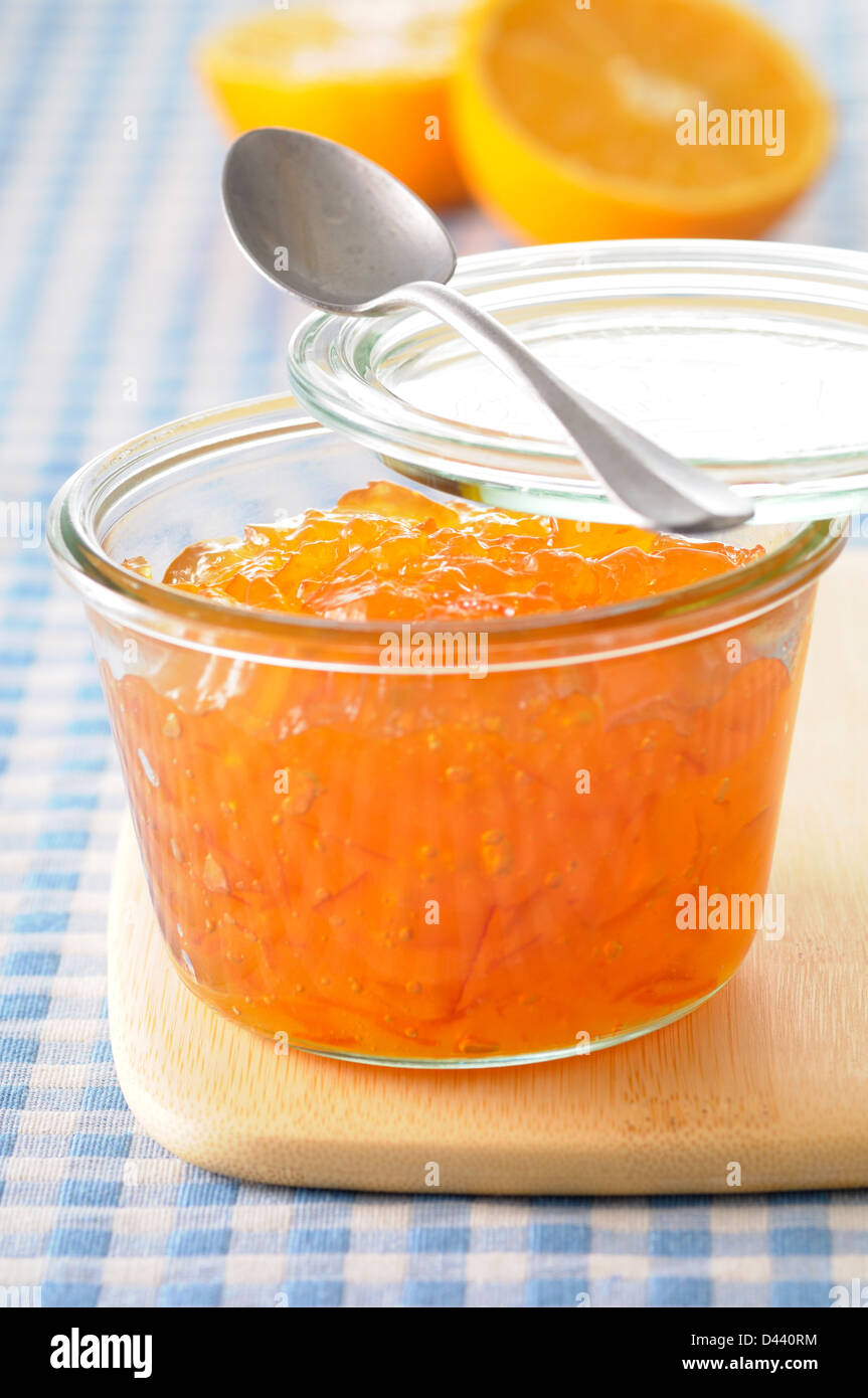 Close-up of Homemade Orange Marmalade with Spoon on Cutting Board Stock Photo