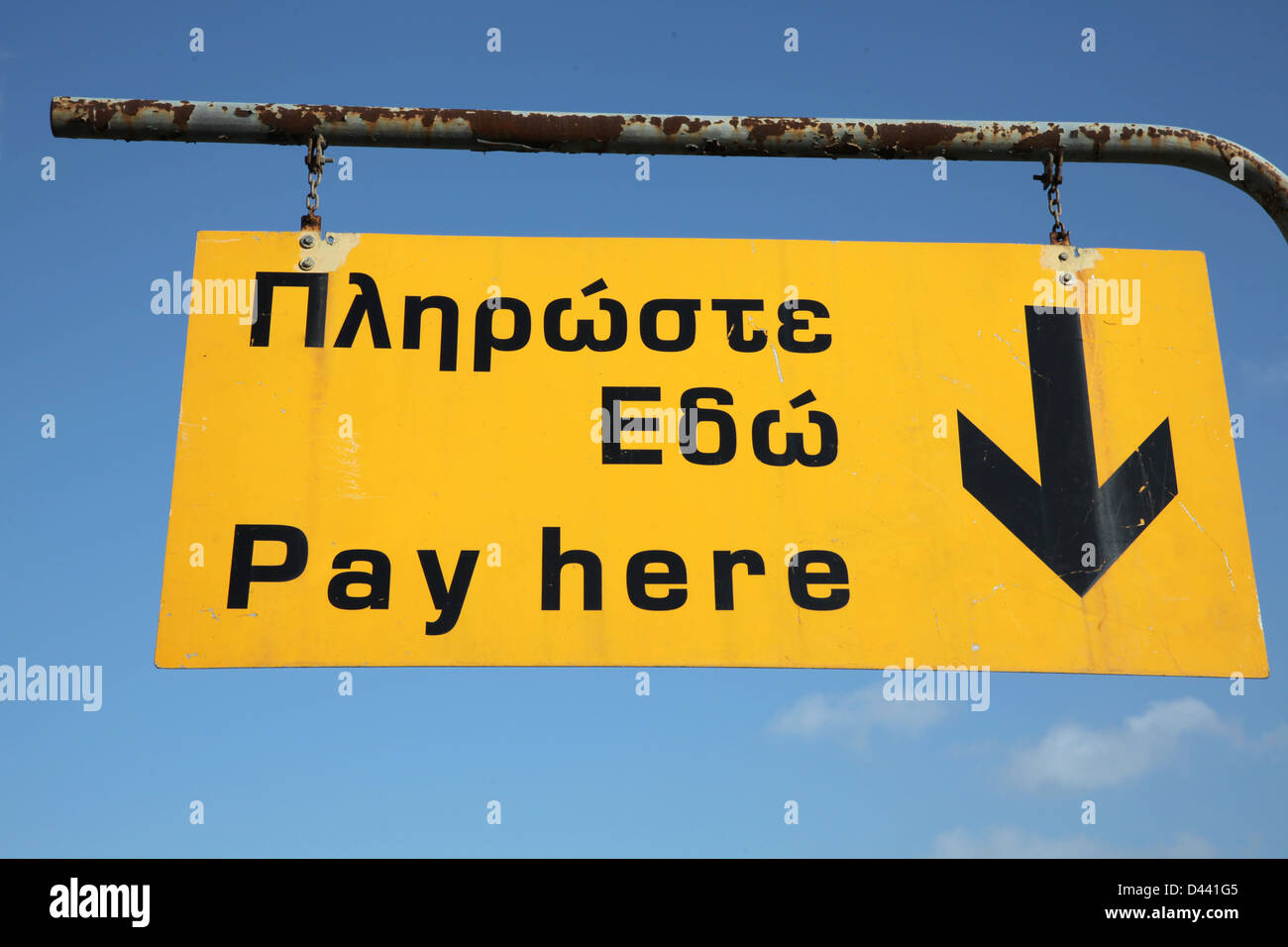 yellow please pay here car parking sign reminding customers Stock Photo