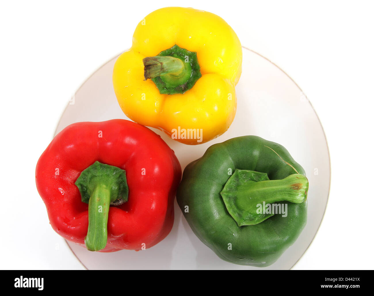 Closeup image of fresh pepper green red and yellow on plate and white background Stock Photo