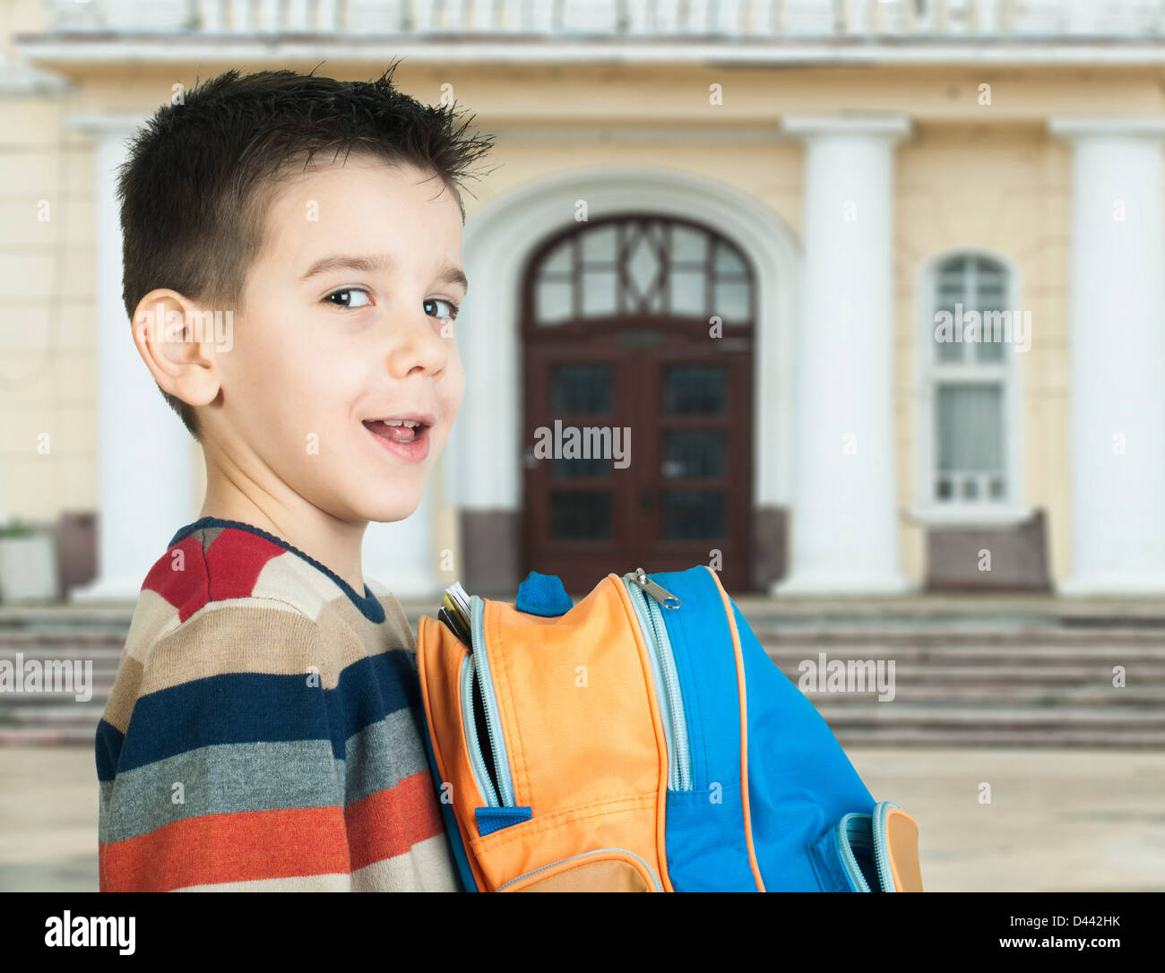 Boy with school bag in front of the school Stock Photo Alamy