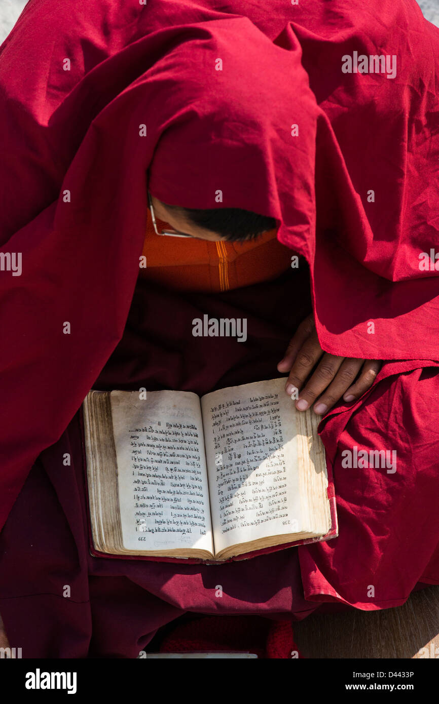 Buddhist monk reading prayers at Boudhanath Stupa, Kathmandu, Nepal Stock Photo
