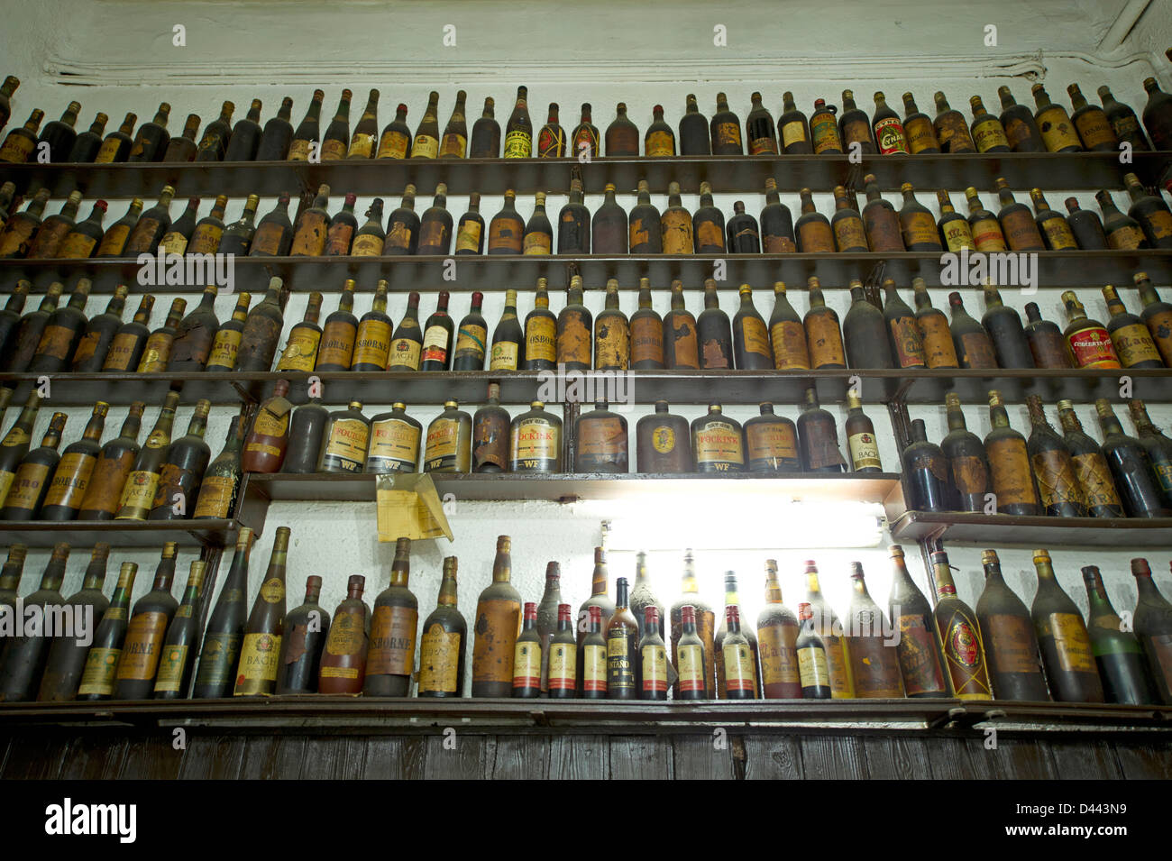 Shelf of dusty liquor bottles in a restaurant in Barcelona Stock Photo