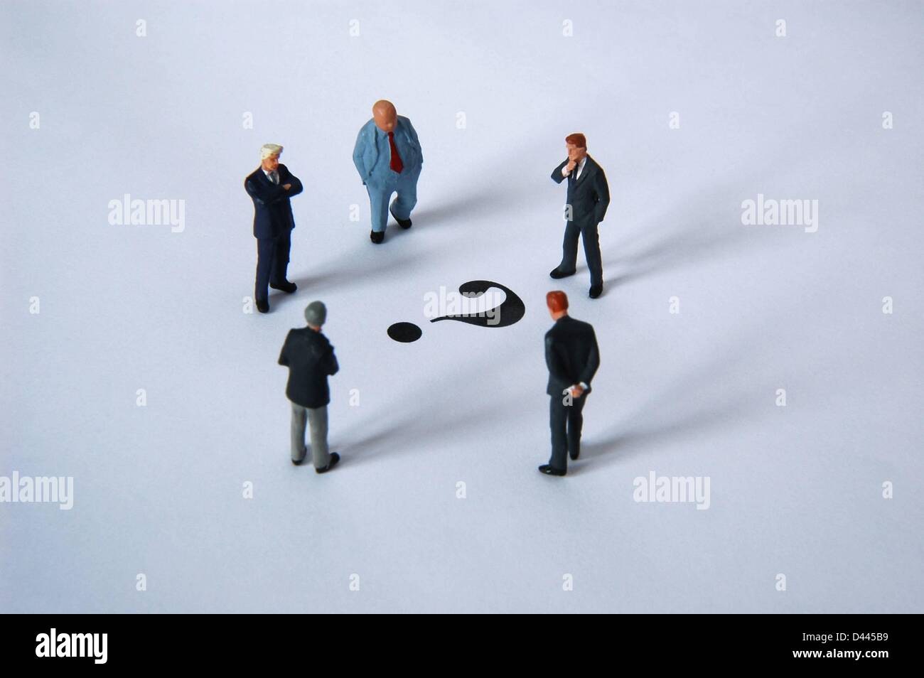 Illustration - Five miniature figures in suits stand around a question mark in Berlin, Germany, 5 December 2007. Fotoarchiv für ZeitgeschichteS.Steinach Stock Photo