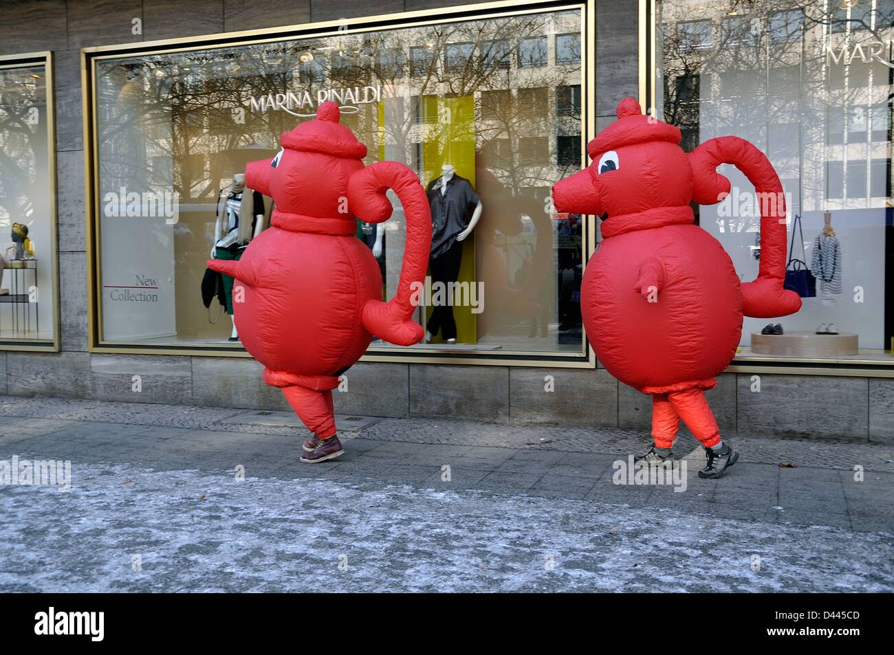 The German supermarkt chain Kaiser's Tengelmann advertises with two promoters wearing red coffee pots on Kurfürstendamm in Berlin, Germany, 12 February 2012. The red coffee pot is the logo of the company. Fotoarchiv für Zeitgeschichte/S.Steinach Stock Photo