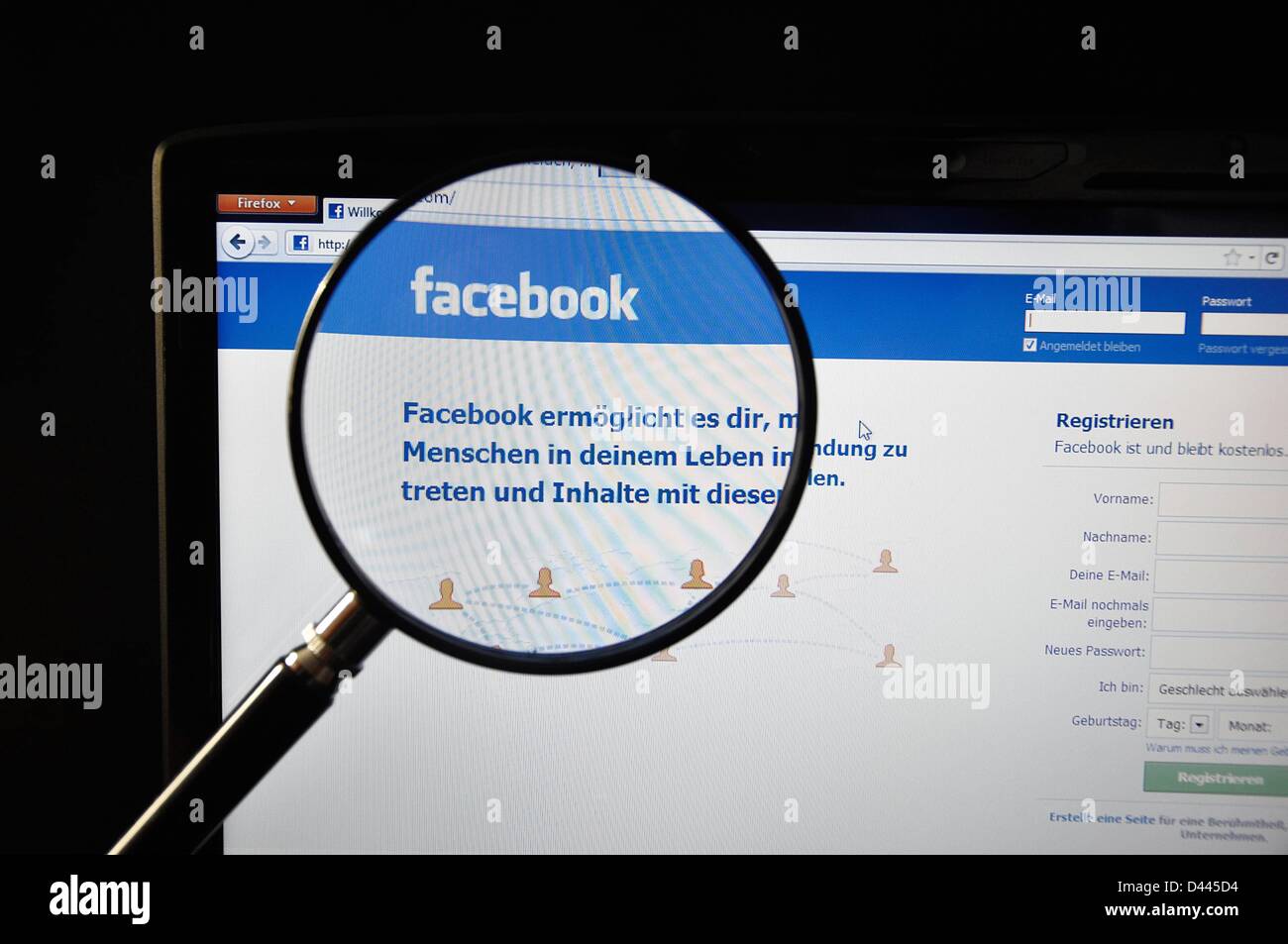 Illustration - A magnifying glass enlarges the logo of 'facebook' on the Facebook Internet page on 9 July 201. In the text that is written beneath it, the German translation of the company's motto is presented: 'Facebook helps you connect and share with the people in your life.' Fotoarchiv für ZeitgeschichteS.Steinach Stock Photo