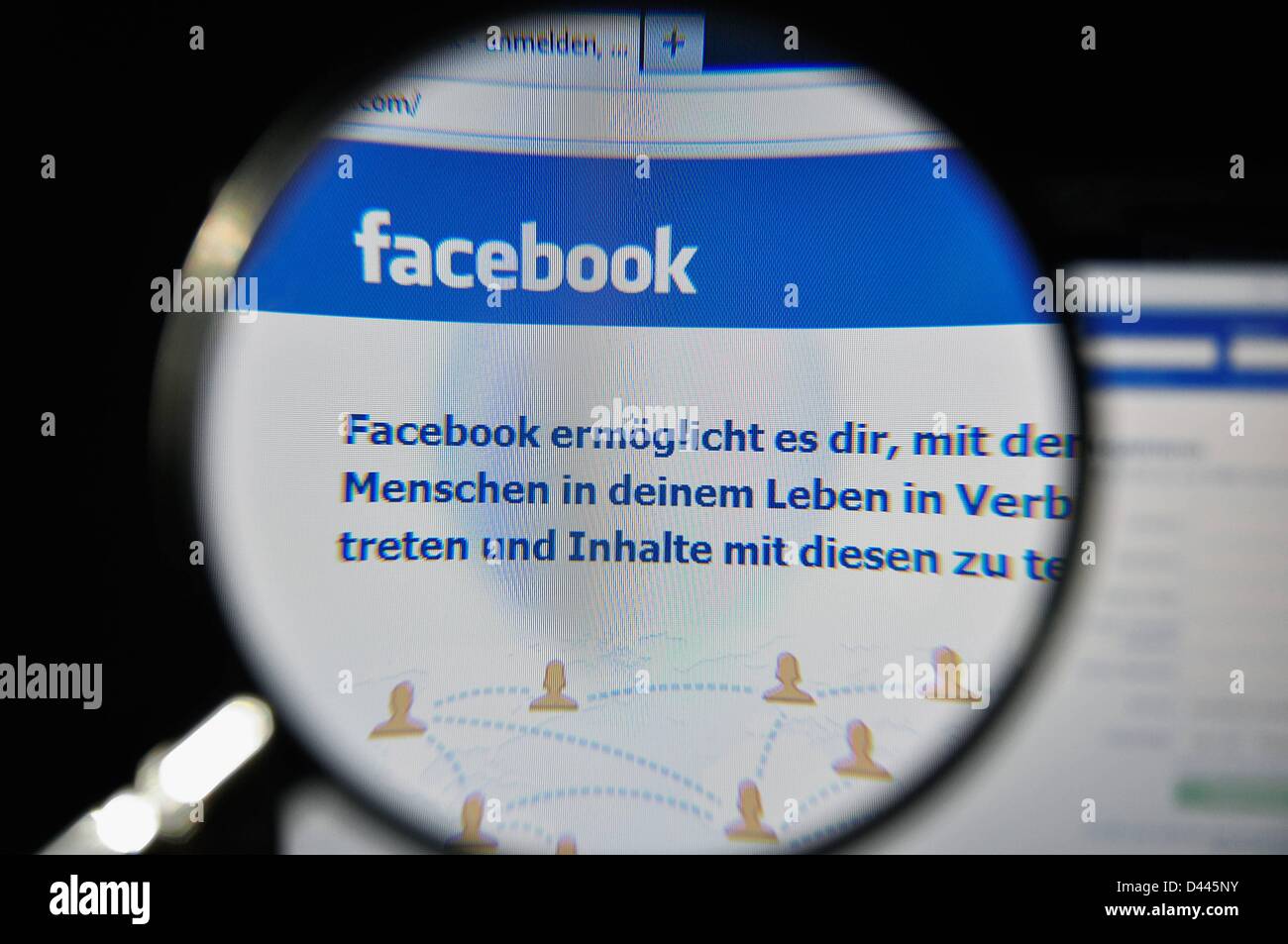 Illustration - A magnifying glass enlarges the logo of 'facebook' on the Facebook Internet page on 9 July 2011. In the text that is written beneath it, the German translation of the company's motto is presented: 'Facebook helps you connect and share with the people in your life.' Fotoarchiv für ZeitgeschichteS.Steinach Stock Photo