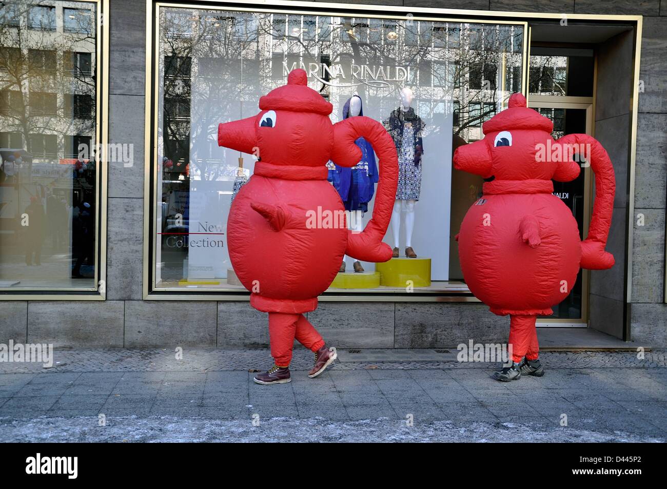 The German supermarkt chain Kaiser's Tengelmann advertises with two promoters wearing red coffee pots on Kurfürstendamm in Berlin, Germany, 12 February 2012. The red coffee pot is the logo of the company. Photo. Berliner Verlag/S.Steinach Stock Photo