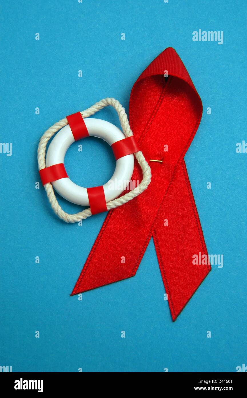 Illustration - A miniature safety buoy is pictured next to the red AIDS ribbon in Berlin, Germany, 10 December 2007. Photo: Berliner Verlag/S.Steinach Stock Photo
