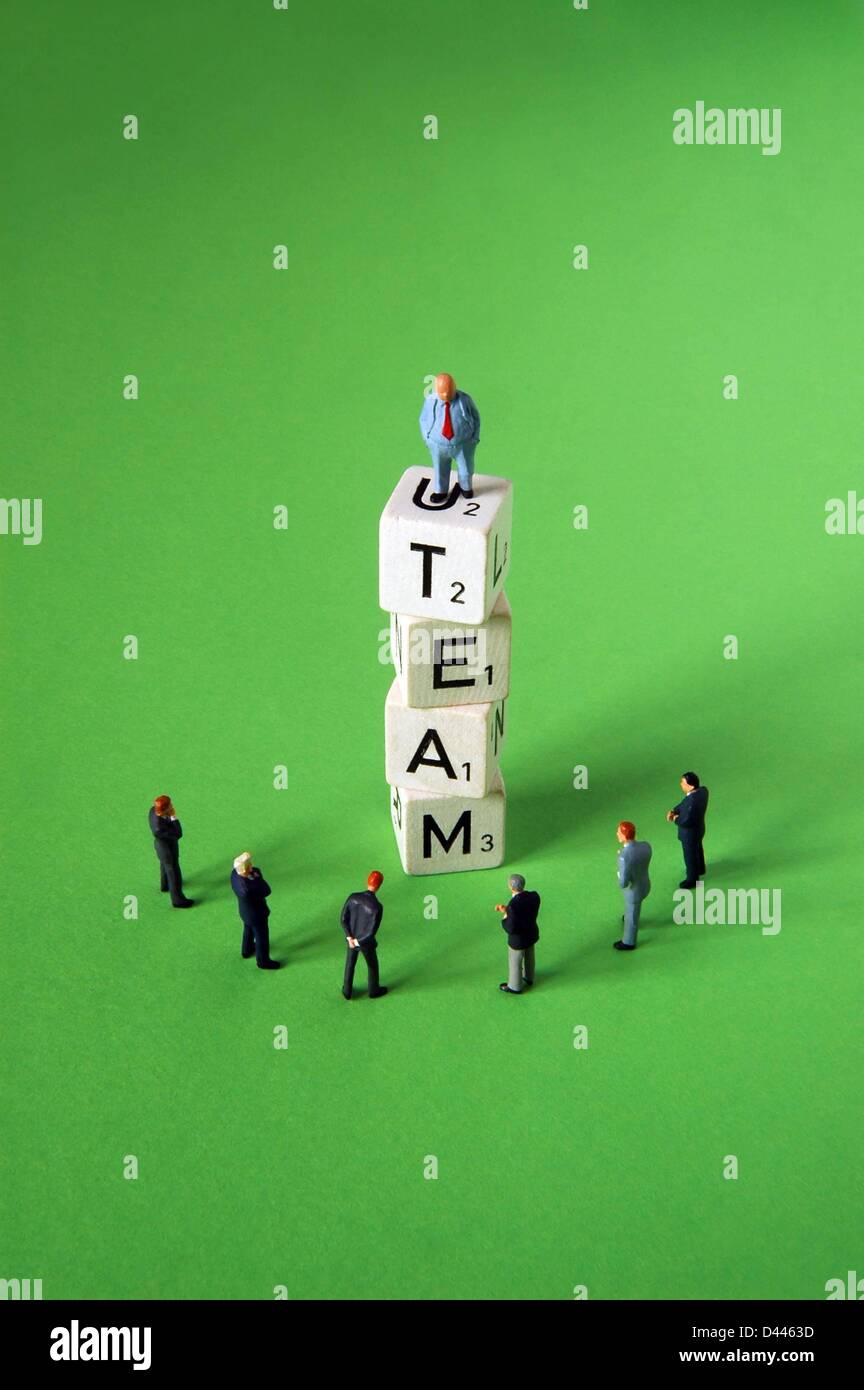 Illustration - A miniature boss figure stands on letter dice forming the word 'TEAM' in front of employee figures in Berlin, Germany, 29 December 2007. Fotoarchiv für ZeitgeschichteS.Steinach Stock Photo