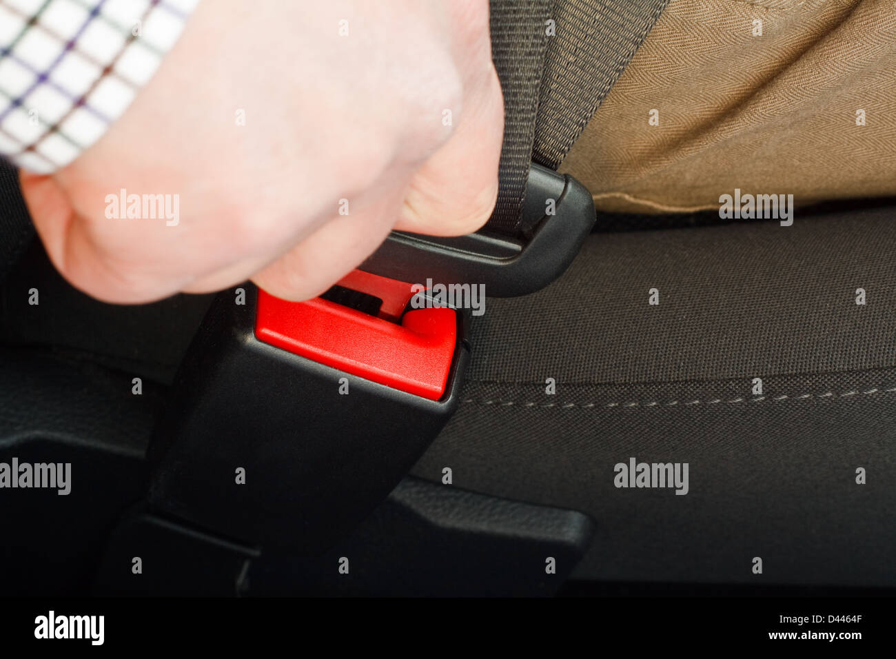 close up of driver or passenger fastening a seatbelt in a motor vehicle front seat Stock Photo