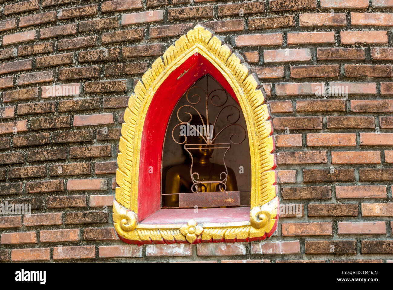 Buddha image through the window of Buddhist monastery (Ubosot) Stock Photo