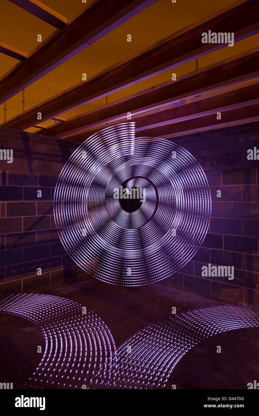 Long exposure of an array of handheld LED lights, moving at speed in a
