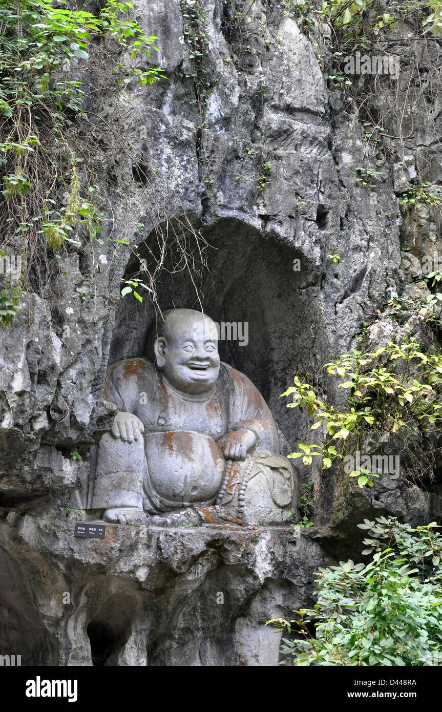 Smiling Buddha statue engraved in the rock - Lingyin temple, Hangzhou near Shanghai, China Stock Photo