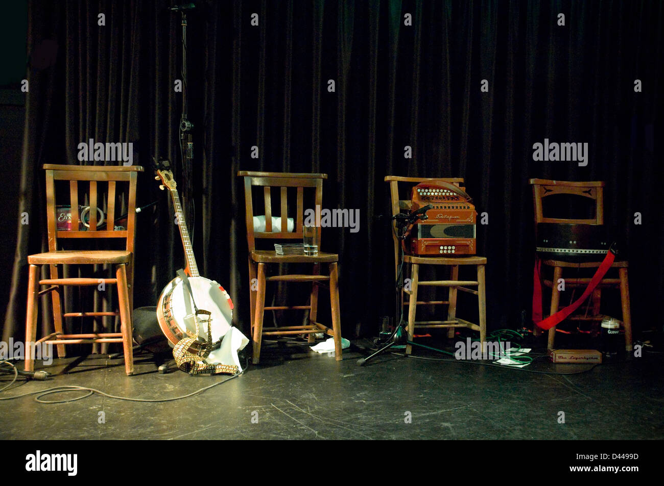 Horizontal close up of traditional Irish instruments set up on stage ready for the band. Stock Photo