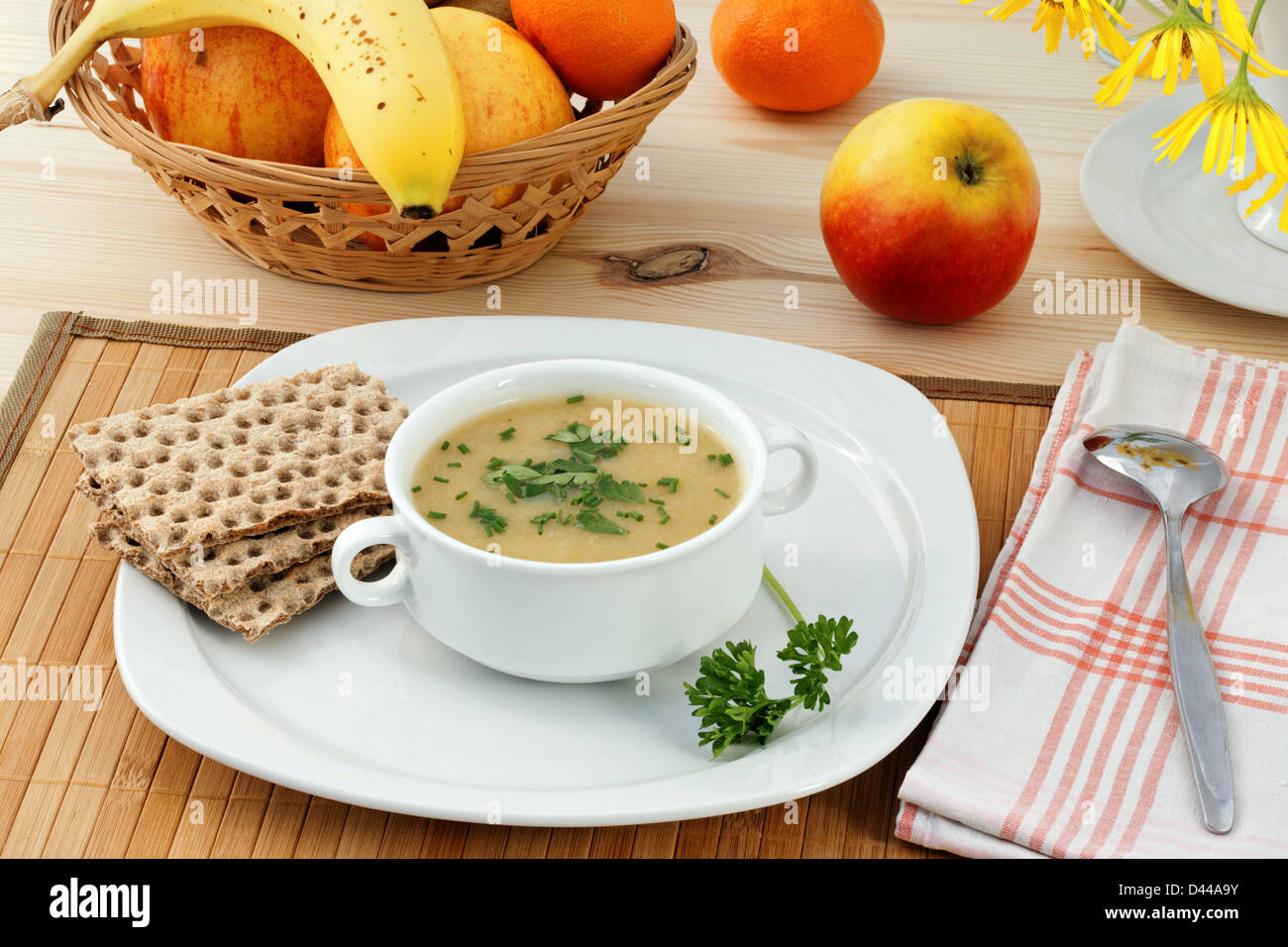 Healthy dinner with vegetable mashed soup and fruits. Stock Photo