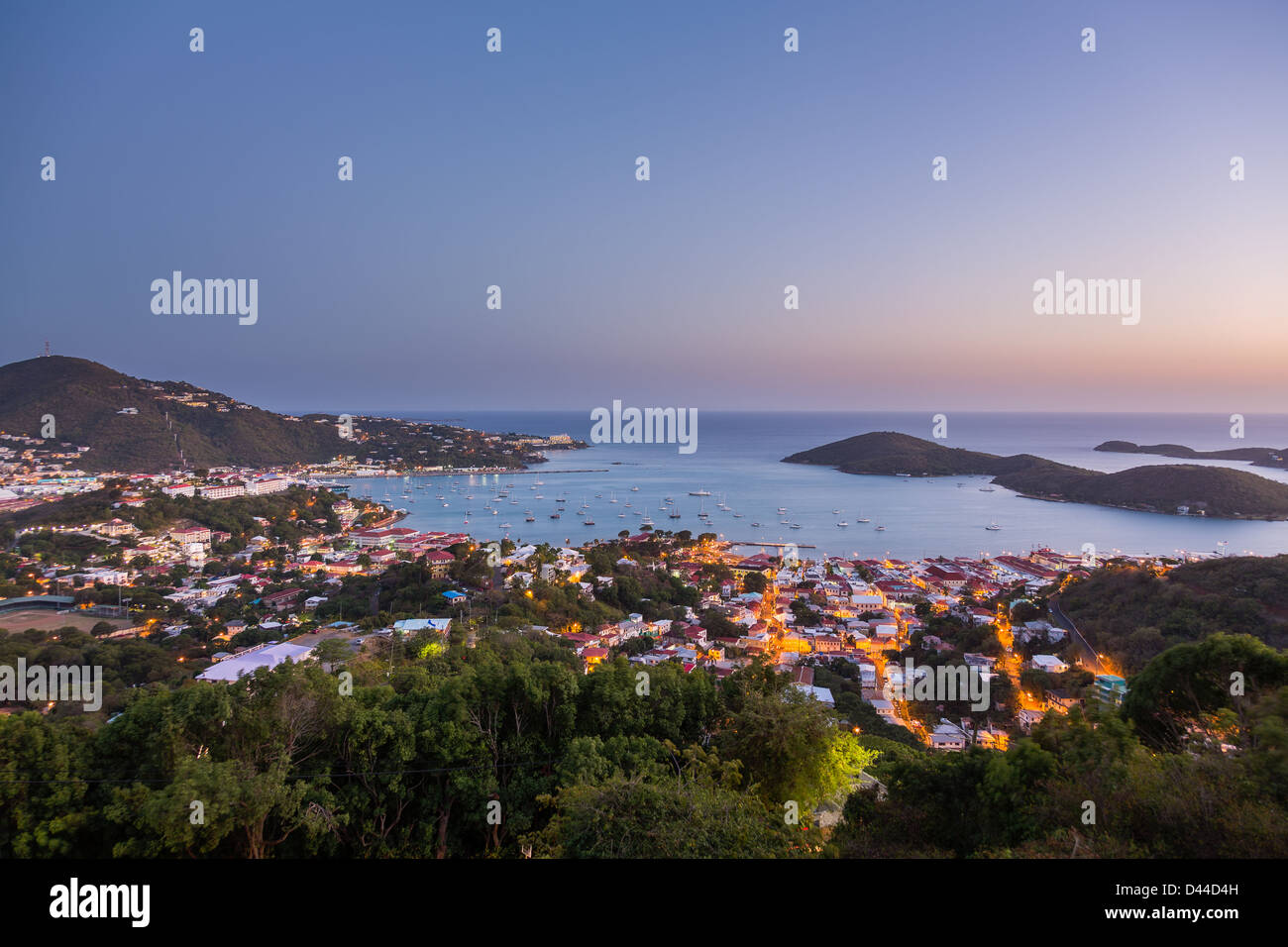 Sunset over the harbor of Charlotte Amalie in St Thomas with view over town and yachts in bay Stock Photo