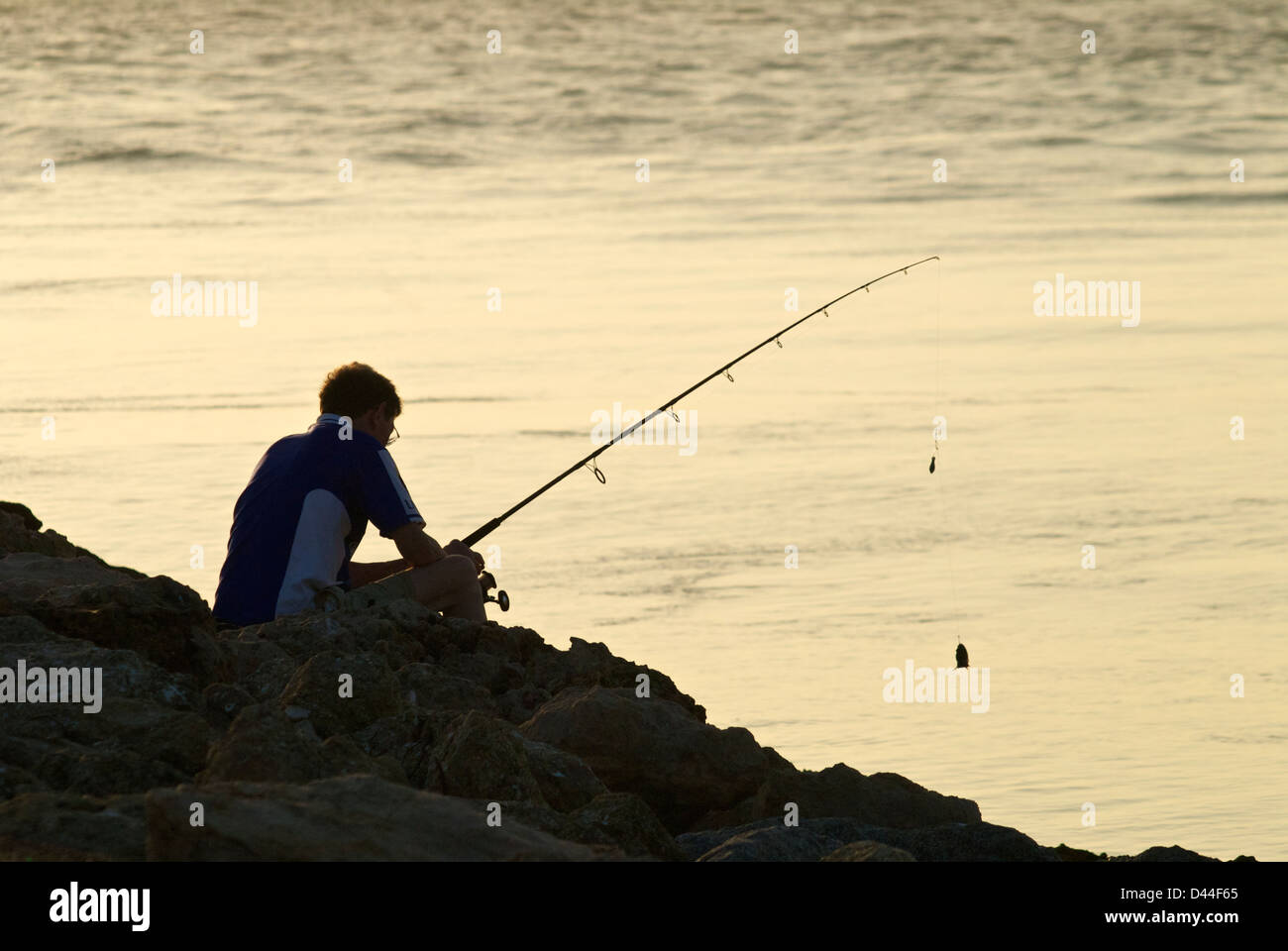fisherman on Venice, Florida jetty at sunset Stock Photo Alamy