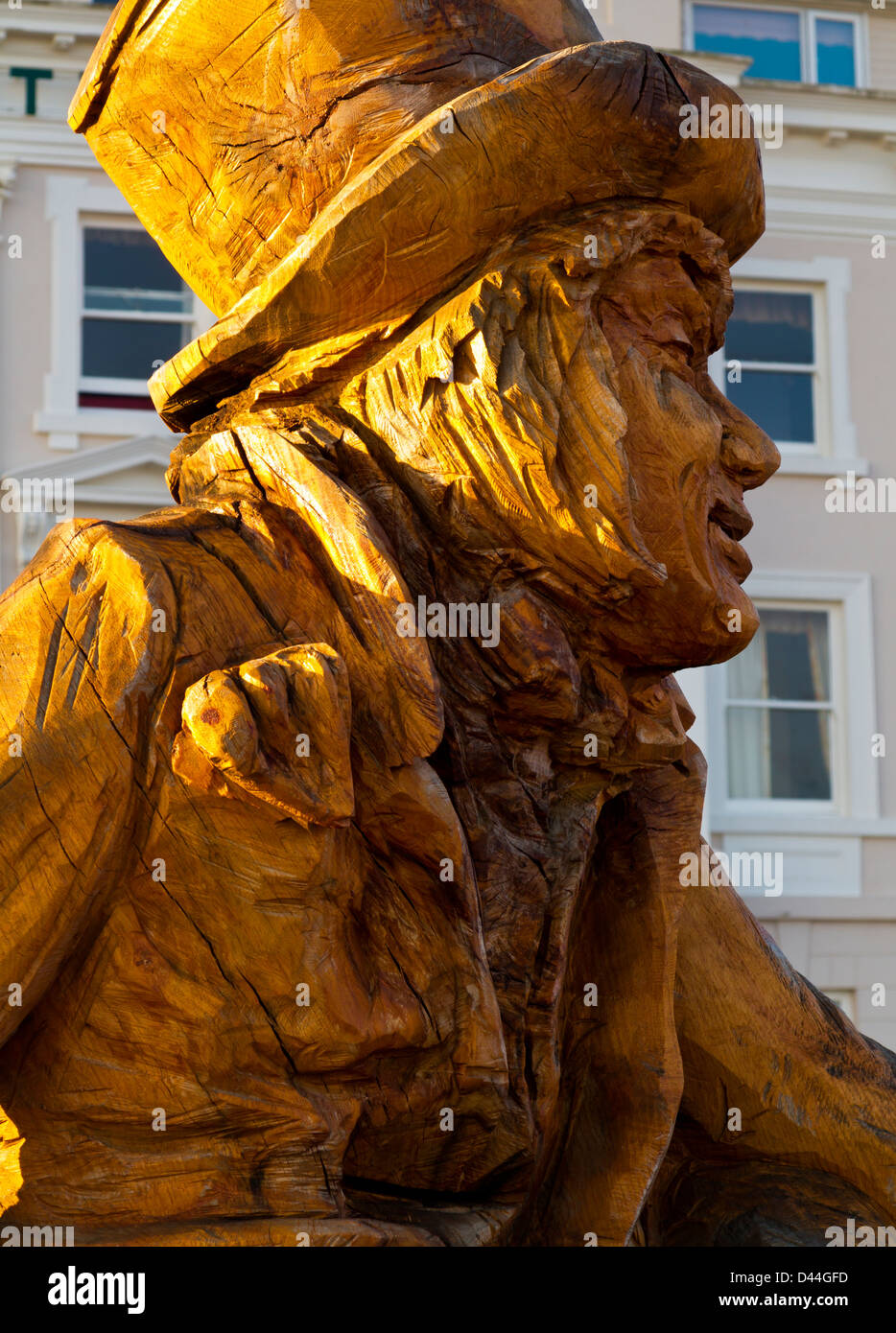 Carved wooden statue of the Mad Hatter by Simon Hedger 2012 on the promenade Llandudno Wales UK to commemorate Lewis Carroll Stock Photo
