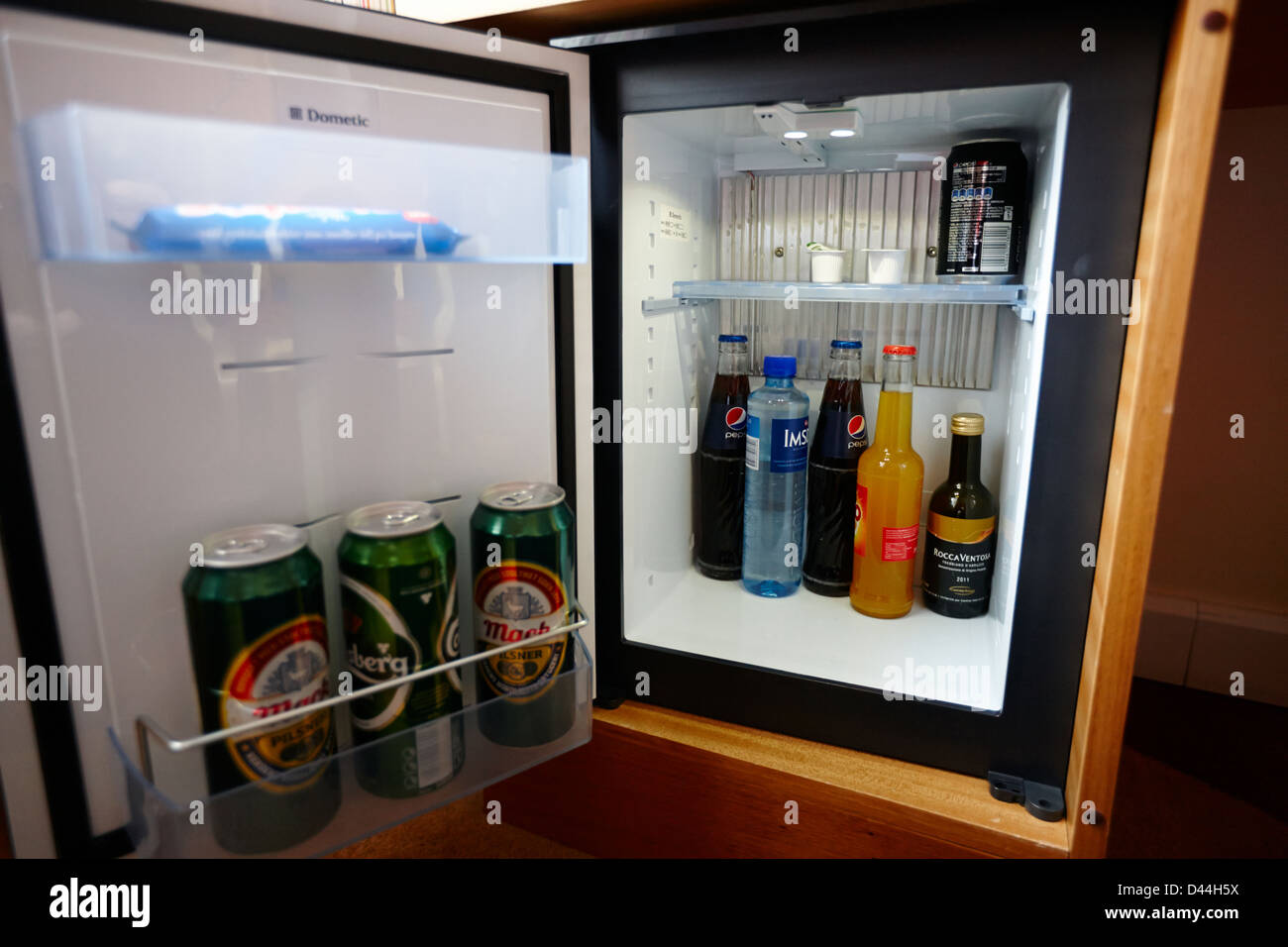 Refrigerator fridge mini size under the table counter with wooden desk  beside it in hotel delux room Stock Photo - Alamy