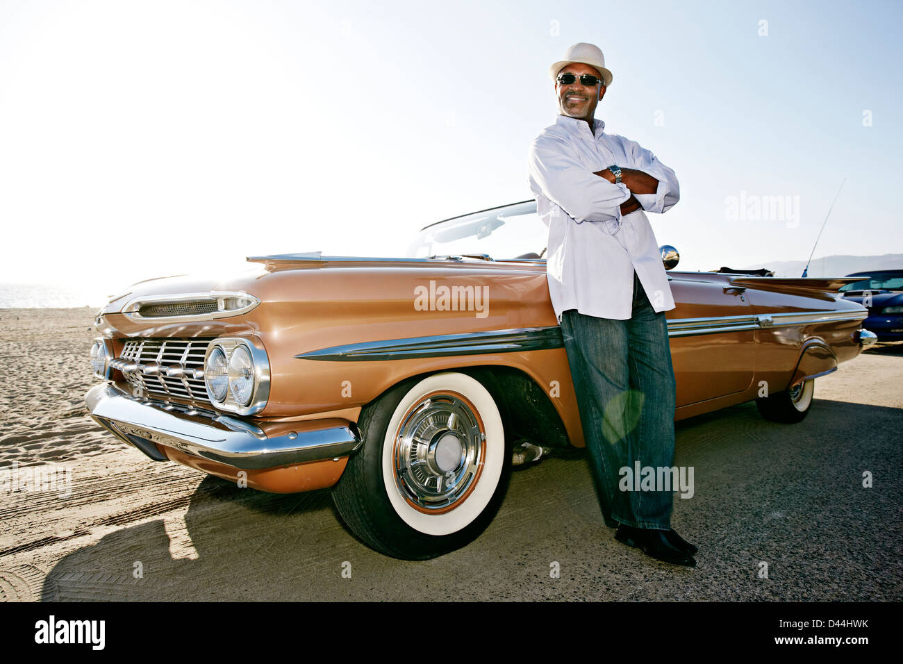 Black man leaning on convertible Stock Photo - Alamy