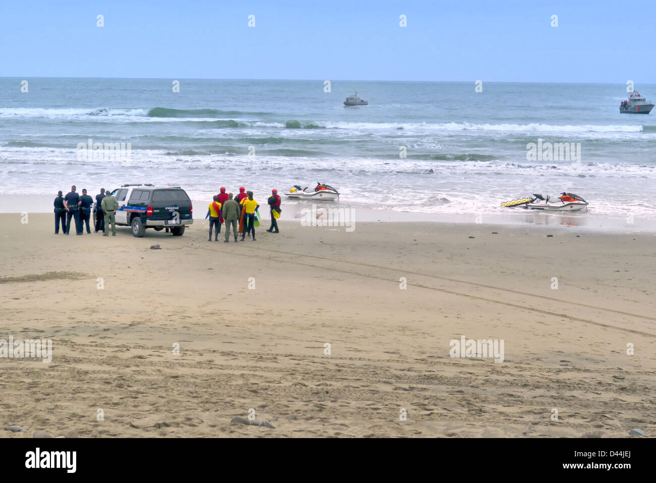 A search and rescue team of first responders assessing an unfolding ocean rescue situation.. Stock Photo